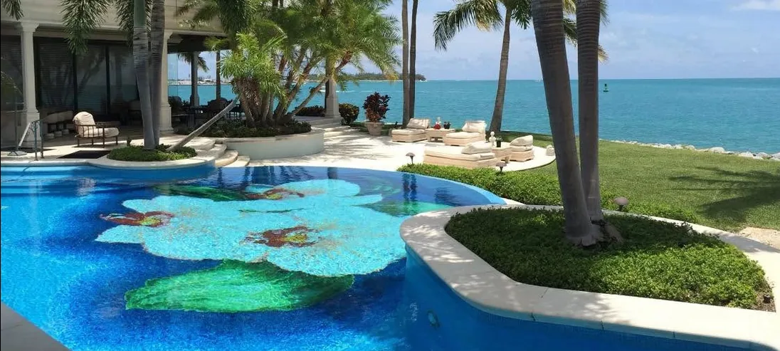 Oceanfront Key West residential pool with a tropical flower mosaic and open-water Atlantic views